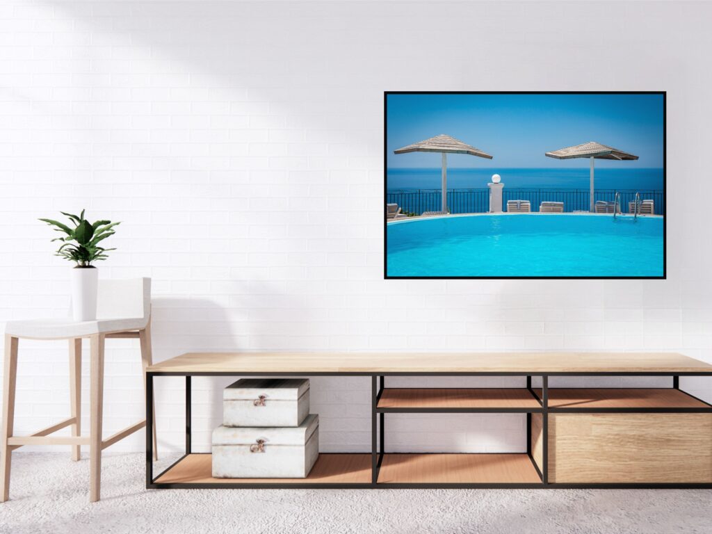 Greece travel poster (blue swiming pool and the sea behind) over cabnet